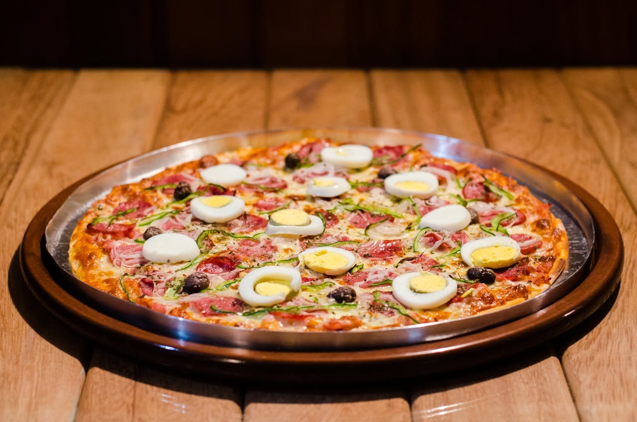 Mouth-watering pizza topped with eggs and meat, perfect for dinner.